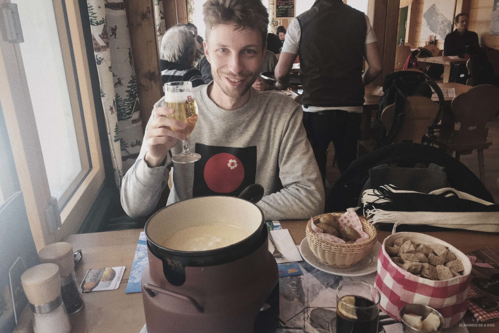 Probando una fondue de queso en Suiza en invierno